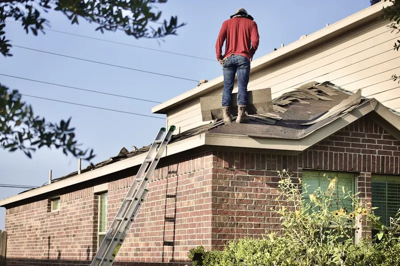Professional roofer working on a residential roof in Ganister